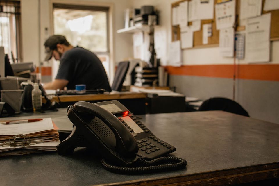 Desk phone ringing in a service-business office