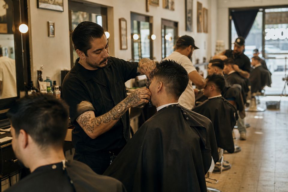 Busy barber shop with every chair full