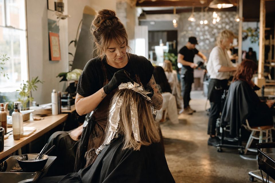 Stylist applying foils in a full salon